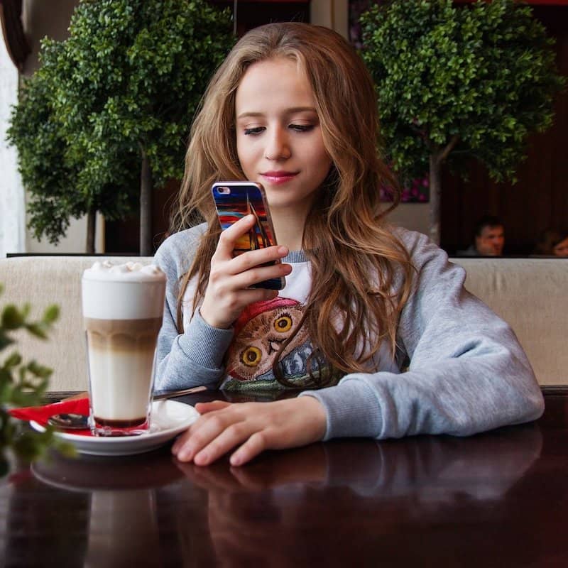 Girl reading a digital menu on smartphone